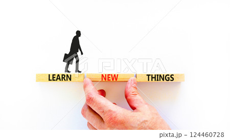 Learn new things symbol. Concept words Learn new things on beautiful wooden blocks. Beautiful white background. Businessman hand. Business motivational learn new things concept. Copy space. 124460728