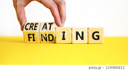 Finding or creating symbol. Businessman turns wooden cubes and changes words Finding to Creating. Beautiful yellow table white background copy space. Business creating or finding concept. Finding or creating symbol. Businessman turns wooden cubes and changes words Finding to Creating. Beautiful yellow table white background copy space. Business creating or finding concept. 124460812