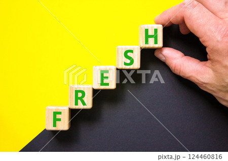 Fresh symbol. Concept word Fresh on beautiful wooden blocks. Beautiful yellow and black background. Businessman hand. Business lifestyle fresh concept. Copy space. 124460816