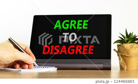Agree to disagree symbol. Concept words Agree to disagree on beautiful black tablet. Businessman hand. Beautiful white background. Business and agree to disagree concept. Copy space. Agree to disagree symbol. Concept words Agree to disagree on beautiful black tablet. Businessman hand. Beautiful white background. Business and agree to disagree concept. Copy space. 124460865