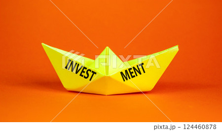 Investment symbol. Concept word Investment on beautiful yellow paper boat. Beautiful orange background. Business investment concept. Copy space. 124460878
