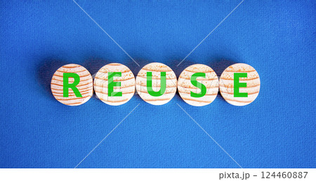 Reuse symbol. Concept word Reuse on beautiful wooden circles. Beautiful blue table blue background. Business lifestyle ecological reuse concept. Copy space. 124460887