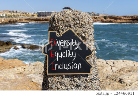 DEI diversity equality inclusion symbol. Concept words DEI diversity equality inclusion on yellow blackboard. Beautiful stone background. Business DEI diversity equality inclusion concept. Copy space. 124460911