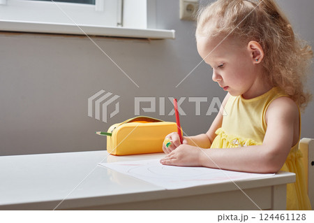 Cute curly blonde girl draws with pencils. Lifestyle Cute curly blonde girl draws with pencils. Lifestyle 124461128