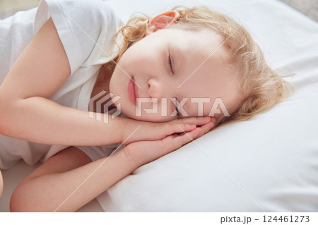 Little girl sleeps on a white pillow. Little girl sleeps on a white pillow. 124461273
