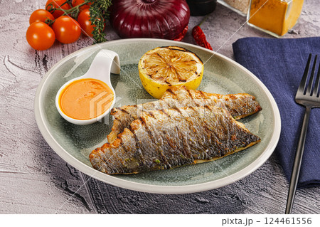 Grilled seabass fillet with lemon Grilled seabass fillet with lemon 124461556