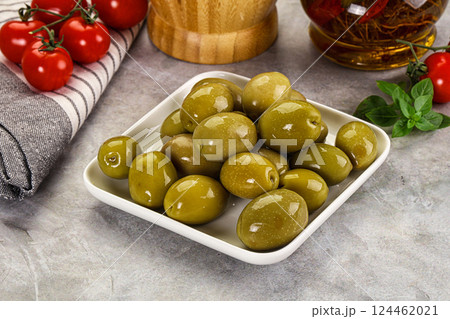 Big green marinated olives in the bowl 124462021