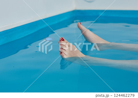 Female legs side view. In a saltwater pool 124462279
