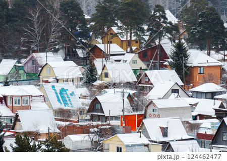 Winter wonderland in a peaceful snowy village surrounded by pine trees and serene tracks 124462477