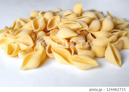 Uncooked dried conchiglie. Pile of shell pasta 124462715