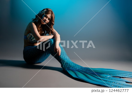 Mermaid cosplay featuring a woman in stunning body art at a studio setting Mermaid cosplay featuring a woman in stunning body art at a studio setting 124462777