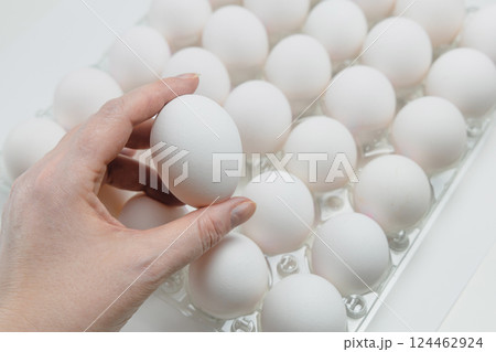 Raw white chicken eggs in tray on white background. 124462924