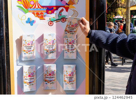 A man takes a brochure of the Tivoli amusement park program. A man takes a brochure of the Tivoli amusement park program. 124462945