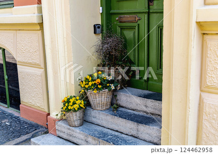 Steps decorated with flower pots and the front door Steps decorated with flower pots and the front door 124462958