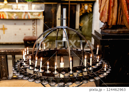 Lit candles in a candelabra in a church. Concept of spirituality 124462963