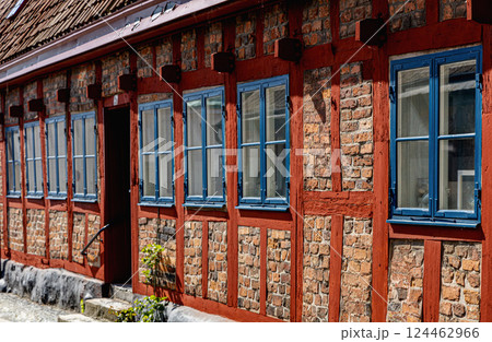 An ancient red brick building on a sunny day against a blue sky. 124462966