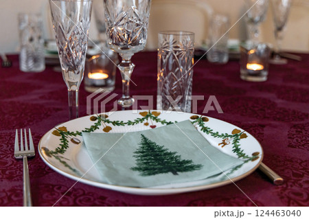 Set Christmas table with Christmas plate and crystal glasses. 124463040