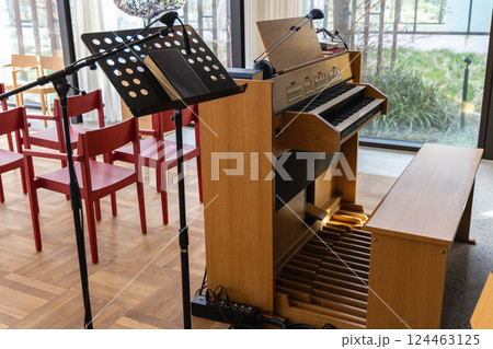 Small indoors pipe organ. Musical instrument for church singing. 124463125