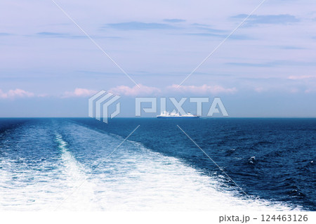 Seascape with a white ferry in the distance and waves. 124463126