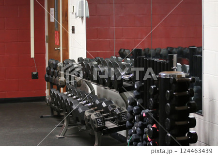 Weightlifting Equipment Arranged Neatly in a Gym Environment Weightlifting Equipment Arranged Neatly in a Gym Environment 124463439