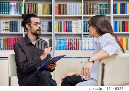 Young professional psychologist male having therapy session with mid adult woman Young professional psychologist male having therapy session with mid adult woman 124463884