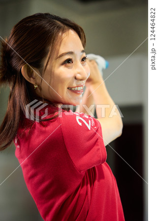 室内ゴルフ練習場で練習をする女性 124464822