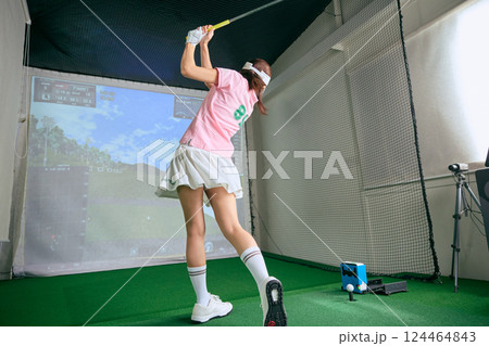 室内ゴルフ練習場で練習をする女性 室内ゴルフ練習場で練習をする女性 124464843