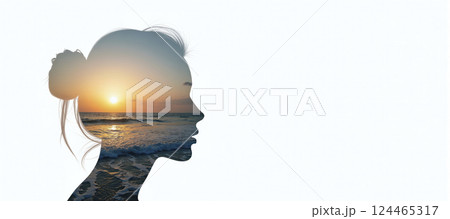 The silhouette of a female head depicting a calm and relaxed landscape, relaxation exercises, stress management and positive thinking 124465317