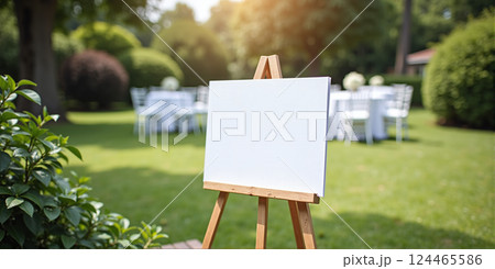 Unwritten blank display with white surface in front of a festive event in nature in summer sunlight 124465586