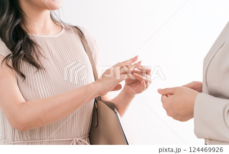 宝石店・アクセサリー・ジュエリーショップ・百貨店で指輪を選ぶ女性と販売員・スタッフ 宝石店・アクセサリー・ジュエリーショップ・百貨店で指輪を選ぶ女性と販売員・スタッフ 124469926