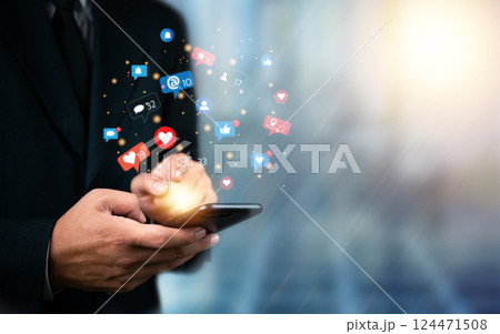 Social media marketing concept. Businessman with digital network, engagement, and marketing connecting through social apps, likes, comments, and notifications on mobile phone. internet technology. Social media marketing concept. Businessman with digital network, engagement, and marketing connecting through social apps, likes, comments, and notifications on mobile phone. internet technology. 124471508