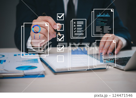 businessman working on a checklist marketing online with data charts and reports visualized digitally, representing task management and analytics. project planning, and business reporting. 124471546