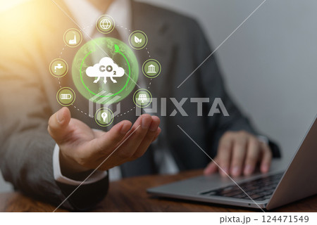 businessman holding a digital CO2 sustainability, representing efforts to reduce carbon emissions. eco-friendly technology, renewable energy, and environmental conservation in modern business. 124471549