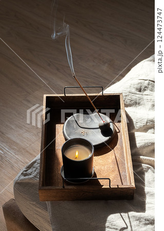 Burning Candle and Aroma Stick Incense on Wooden Tray for Calm Balance and Wellbeing. Burning Candle and Aroma Stick Incense on Wooden Tray for Calm Balance and Wellbeing. 124473747