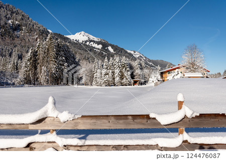 Winter landscape snow-covered nature and fence in the Bavarian Alps, Germany 124476087