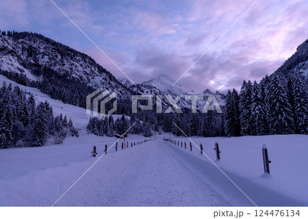 Snow-covered road at sunset, winter scenery in the Bavarian Alps, Germany Snow-covered road at sunset, winter scenery in the Bavarian Alps, Germany 124476134