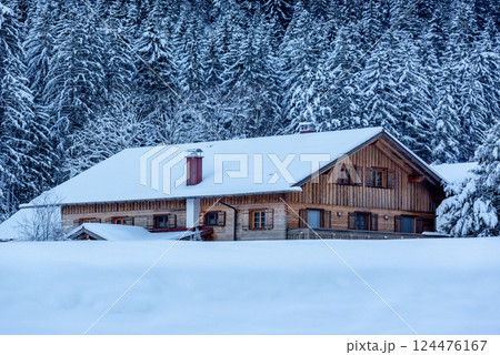 Log cabin covered in deep snow in December, in the Bavarian Alps, Germany 124476167