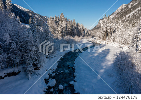 River in winter deep snow scenery, drone aerial view in the Bavarian Alps, Germany 124476178