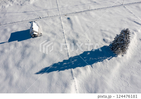 Snow-covered church in bright light, winter aerial view in the Bavarian Alps, Germany 124476181
