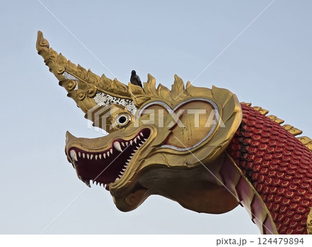 Thai-styled dragon, called naga, with small bird. 124479894