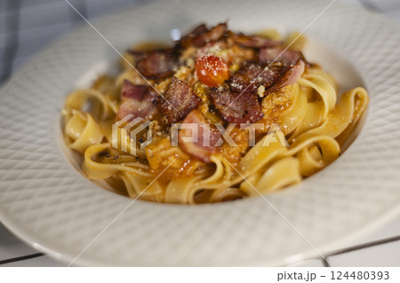 Fettuccine Pasta With Bacon And Red Sauce 124480393