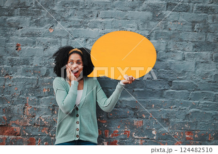Social media, wow and woman with speech bubble against a wall in city for marketing, business and news. Portrait, happy and surprise face from girl with chat on a board and advertising communication Social media, wow and woman with speech bubble against a wall in city for marketing, business and news. Portrait, happy and surprise face from girl with chat on a board and advertising communication 124482510
