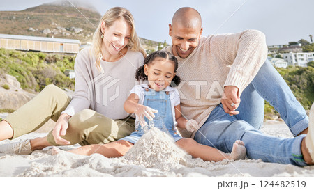 Happy, beach and family with castle in sand for summer, freedom and travel vacation together. Love, smile and relax with mother and father playing with girl for holiday, lifestyle and building 124482519