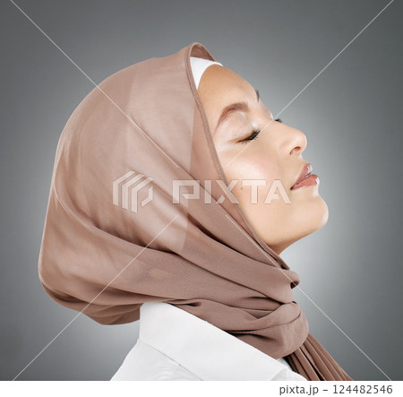 Woman, muslim and beauty in hijab scarf embracing islamic religion against a grey studio background. Beautiful head of female model in islam with calm, peaceful face in makeup, cosmetic or treatment Woman, muslim and beauty in hijab scarf embracing islamic religion against a grey studio background. Beautiful head of female model in islam with calm, peaceful face in makeup, cosmetic or treatment 124482546