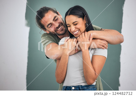 Happy, couple and hug for love, home improvement and smile against a painted wall background. Man and woman smiling for creative interior design in relationship, painting or house renovation together Happy, couple and hug for love, home improvement and smile against a painted wall background. Man and woman smiling for creative interior design in relationship, painting or house renovation together 124482712