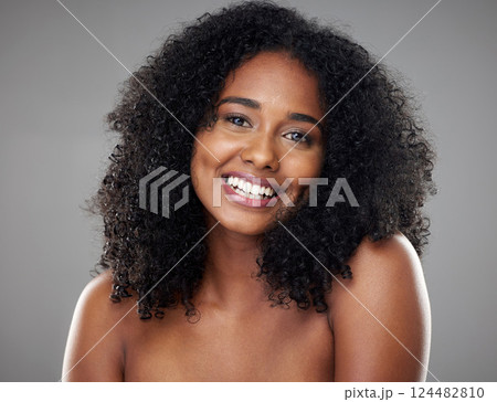 Happy, smile and portrait of a young woman with clean, beautiful and natural hair in a studio. Happiness, beauty and face of girl model with afro from Brazil smiling while isolated by gray background Happy, smile and portrait of a young woman with clean, beautiful and natural hair in a studio. Happiness, beauty and face of girl model with afro from Brazil smiling while isolated by gray background 124482810