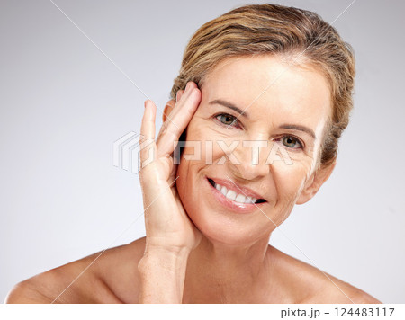 Senior woman, beauty and hand on face on gray studio background. Portrait, skincare model and smile of happy lady from Canada with beautiful glowing skin, wellness and healthy facial care routine. 124483117