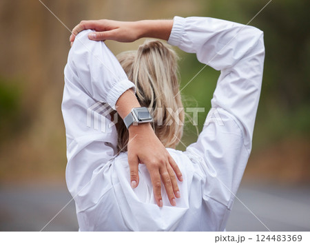 Fitness, warm up and woman stretching in the park before exercising, running and workout. Health, wellness and sports girl doing stretch for back and arm muscles before exercise, ready to run on road 124483369