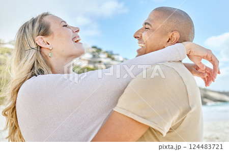 Beach, hug and interracial love of couple with happy and cheerful smile enjoy vacation in Brazil. Happiness, care and romance of lovers embracing for joyful moment on ocean holiday break. 124483721
