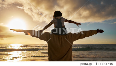 Father child and shoulders flying on the beach in the sunset together for family bonding in the outdoors. Dad with kid pretend to fly on piggyback fun for relationship, love and care in nature 124483740